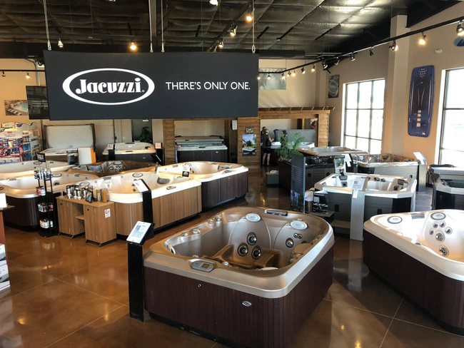 A showroom filled with lots of jacuzzi hot tubs.