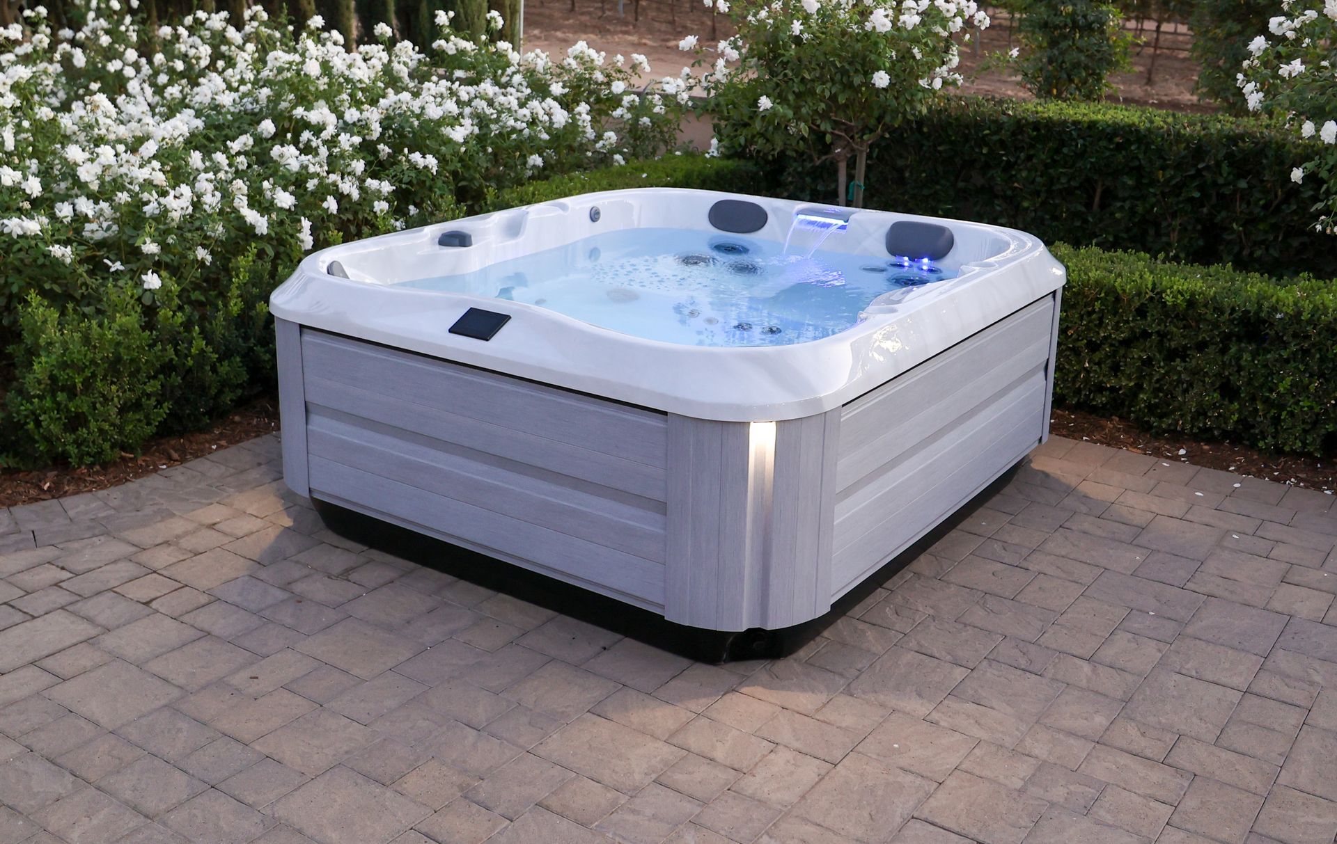 A silver hot tub is sitting on a white surface.