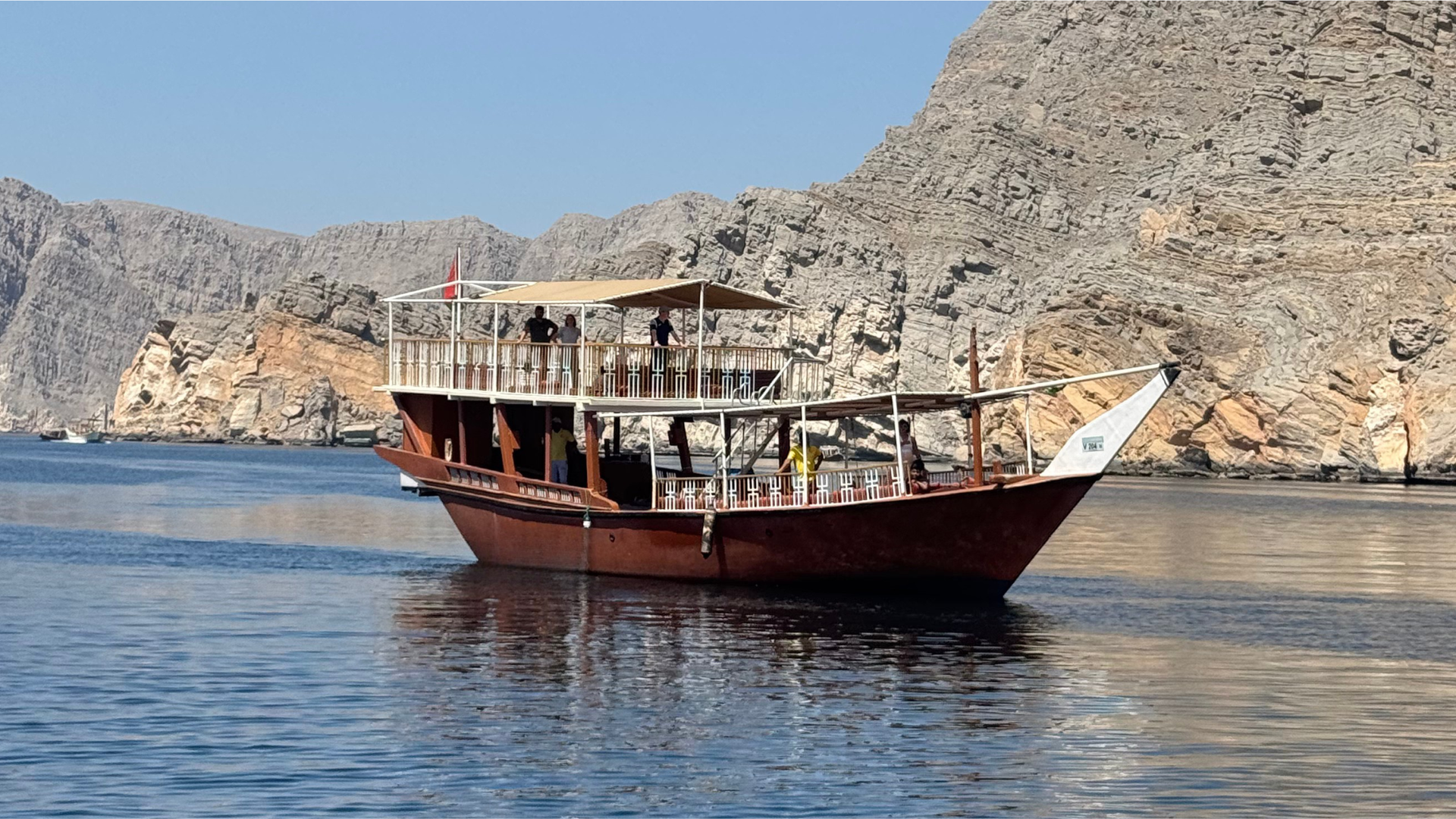 Traditional dhow anchored in Khasab fjords under a sky full of stars during a Musandam trip.