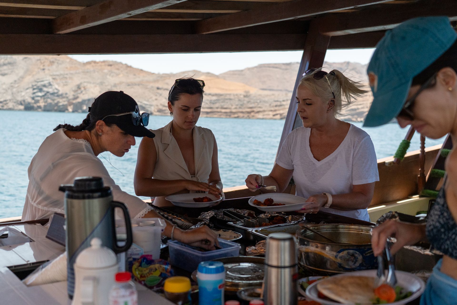 Buffet-style meal setup on a traditional dhow during a Musandam trip with Arabian Wanderers.