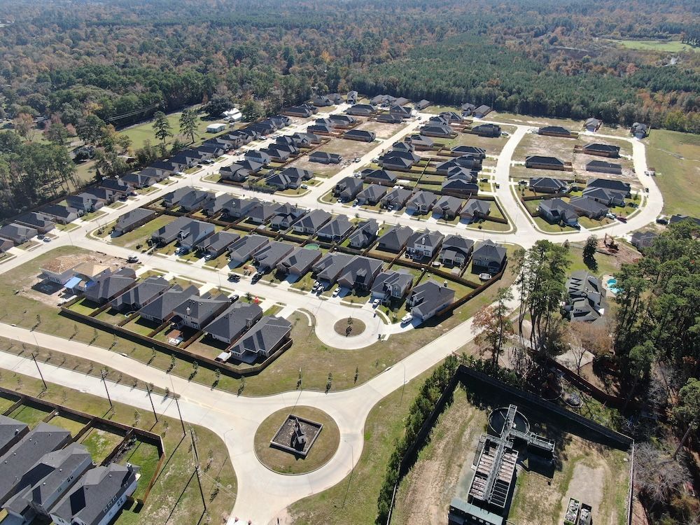 An aerial view of a residential area with lots of houses and trees.