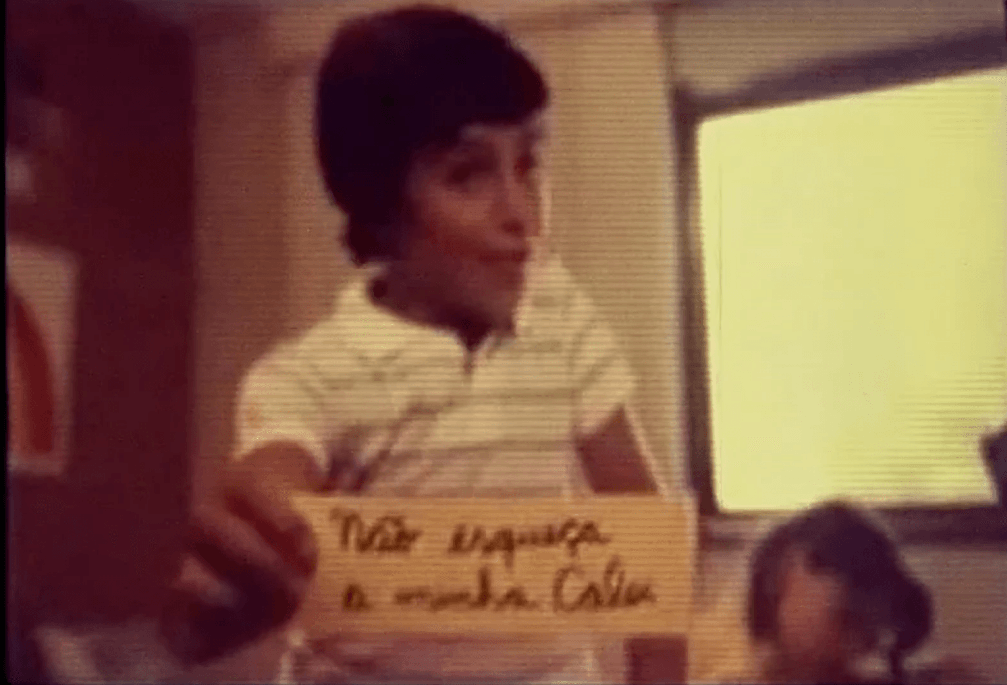 A young boy is holding a sign that says 