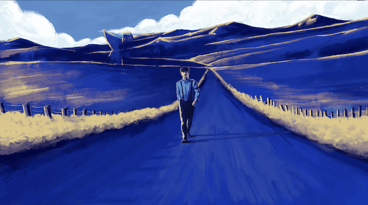 Um homem está andando por uma estrada no meio de um campo.