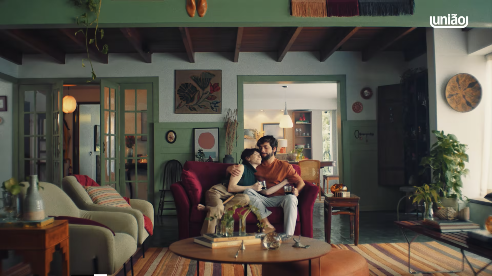 Um homem e uma mulher estão sentados em um sofá na sala de estar.