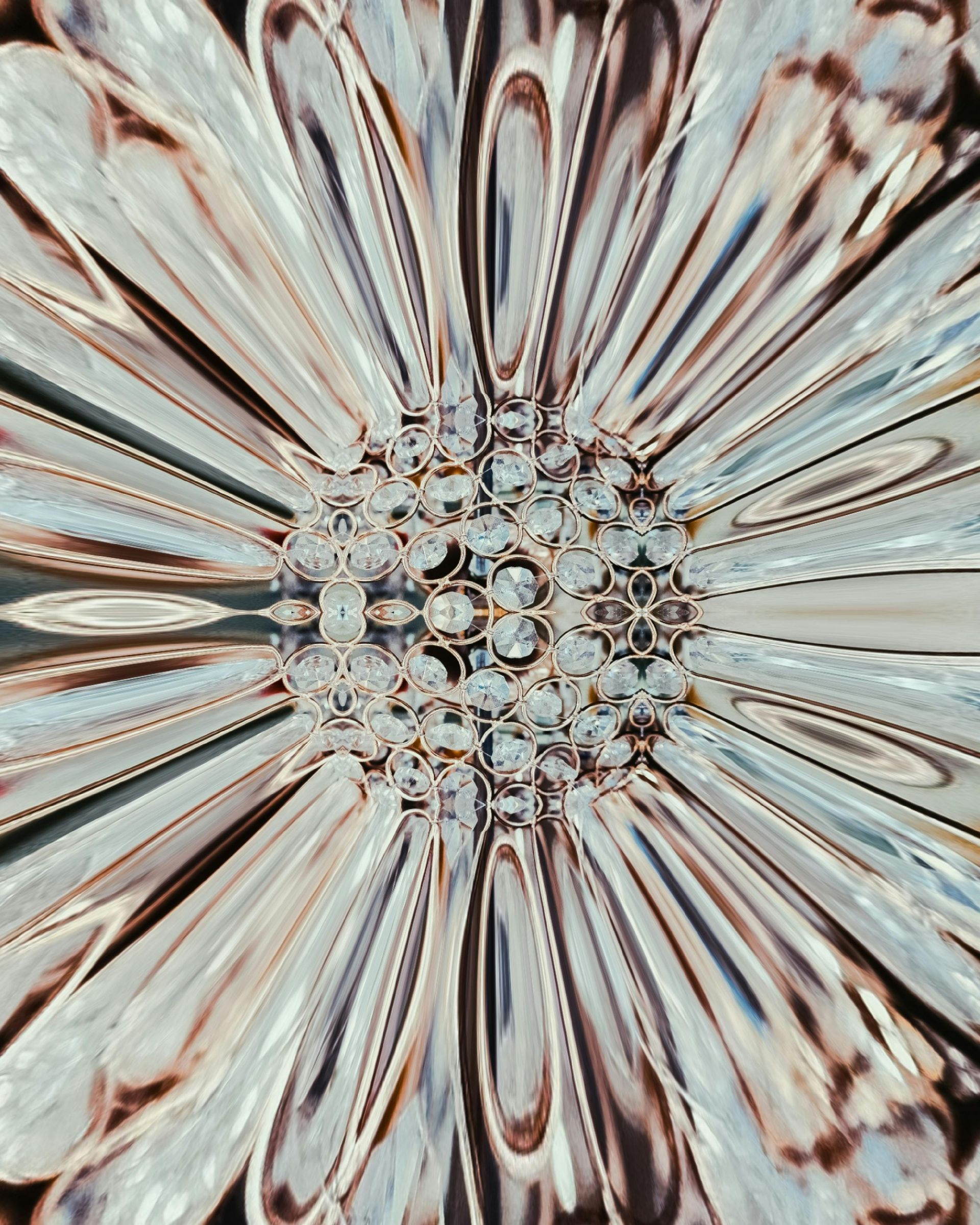 Abstract close-up of a shimmering, crystal-like flower with radiating petals, mostly in white, silver, and brown.