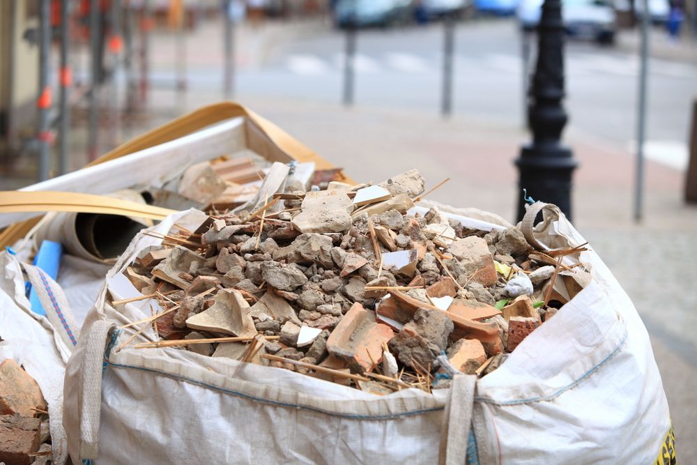 Bag of Construction Debris on a City Street, Including Broken Bricks and Rubble — Resolute Home Services In Oakey, QLD