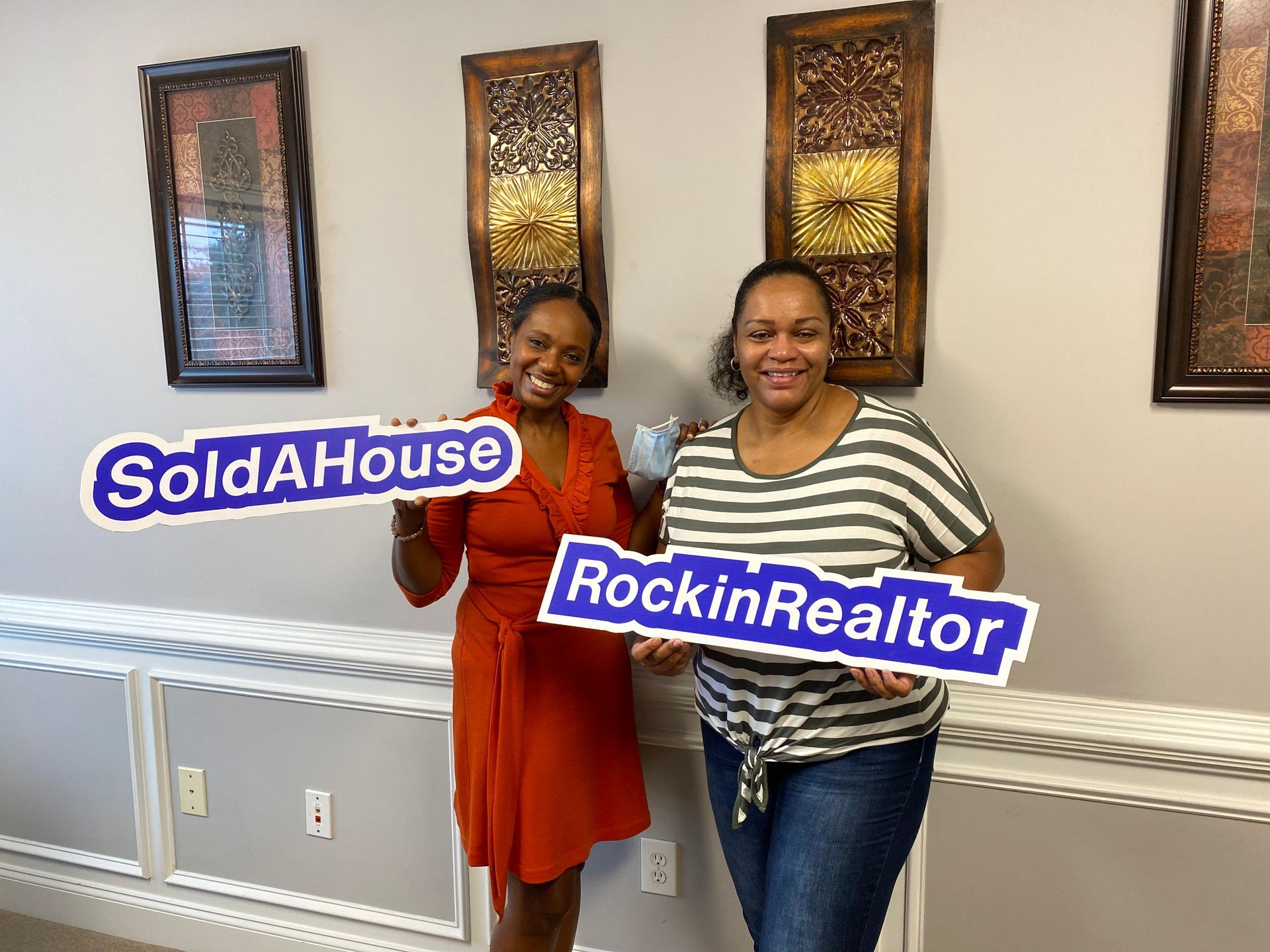 A patio with a lot of furniture and lights at night.