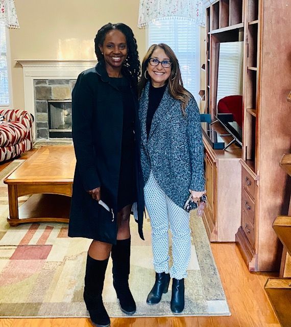 A dining room with a round table and chairs.