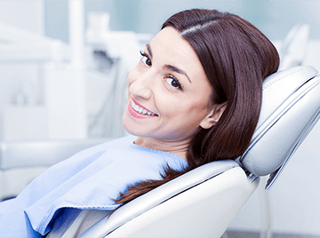 Woman Smiling in Dentist Chair | Root Canals in Webster City & Humboldt, IA