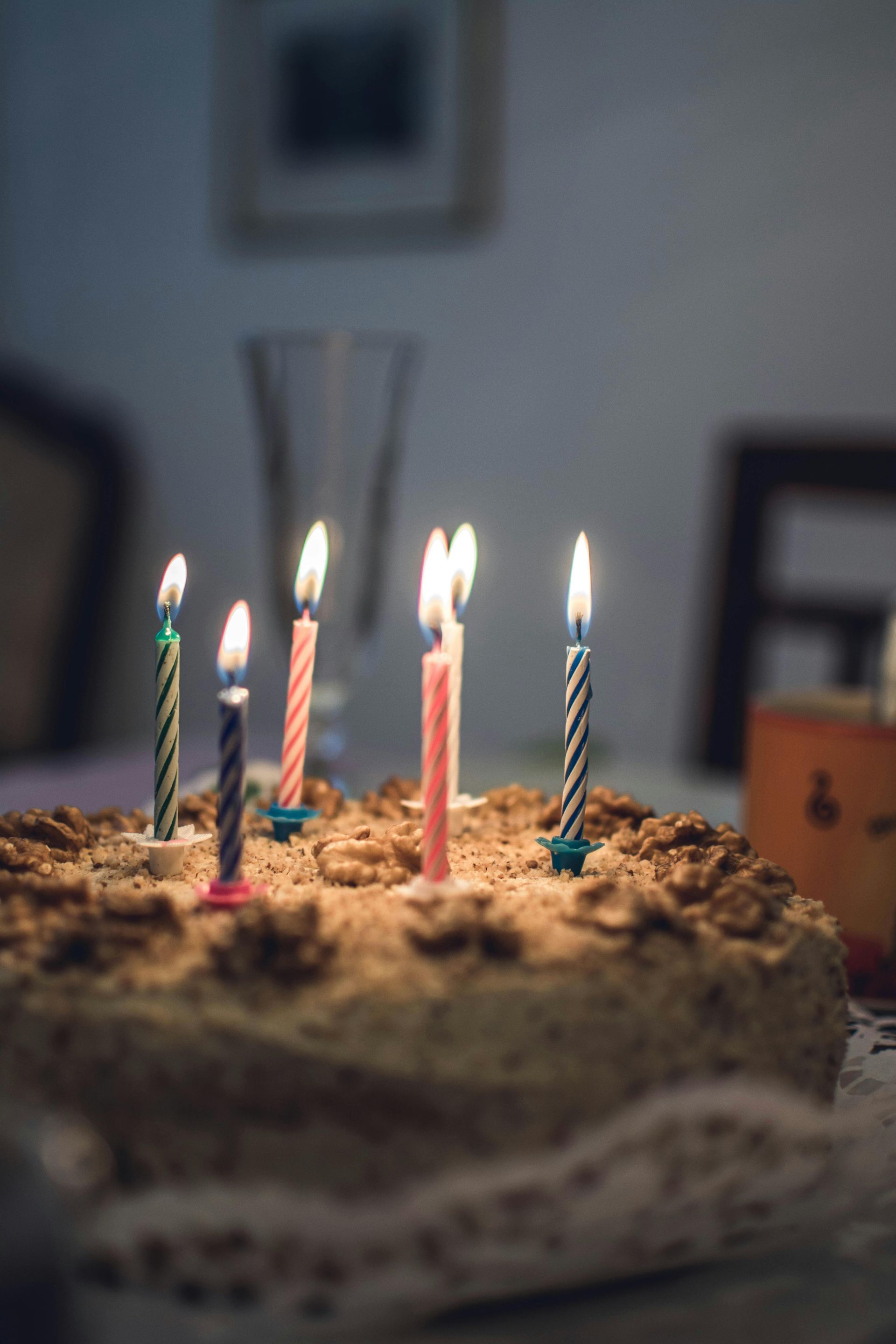 A birthday cake with candles on it is on a table.