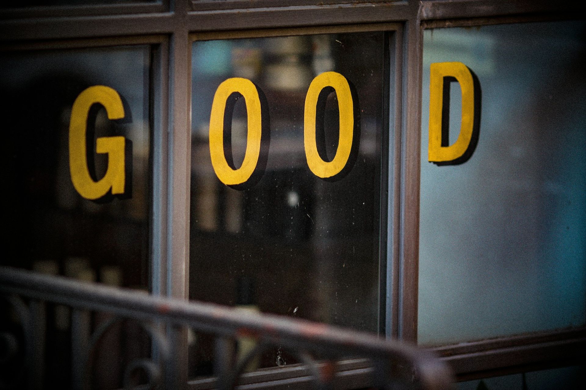 A window with the word good painted on it.
