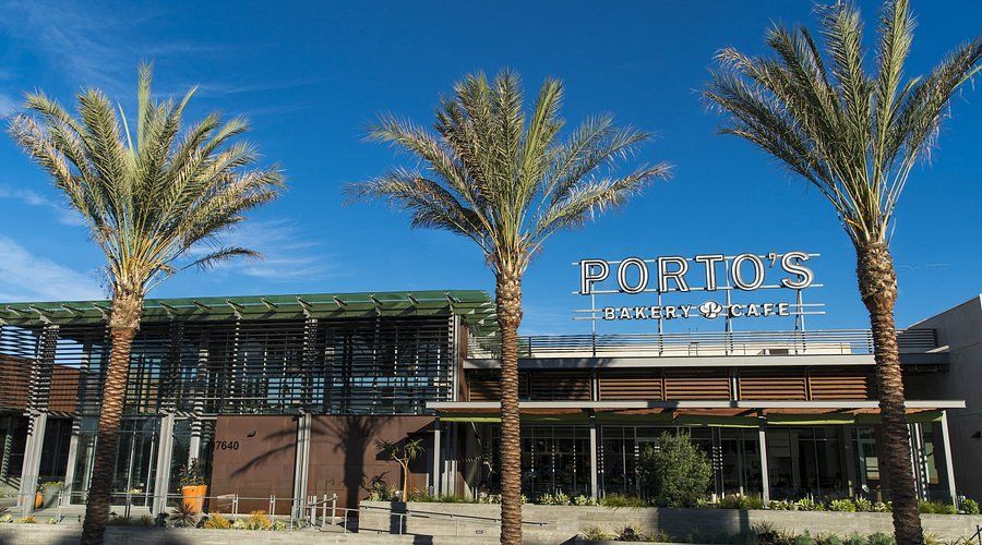 Fortol's Italian restaurant with three palm trees under a clear blue sky.