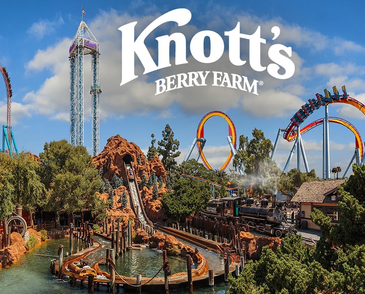 Knott's Berry Farm amusement park, roller coasters, water ride, trees, and blue sky with clouds.
