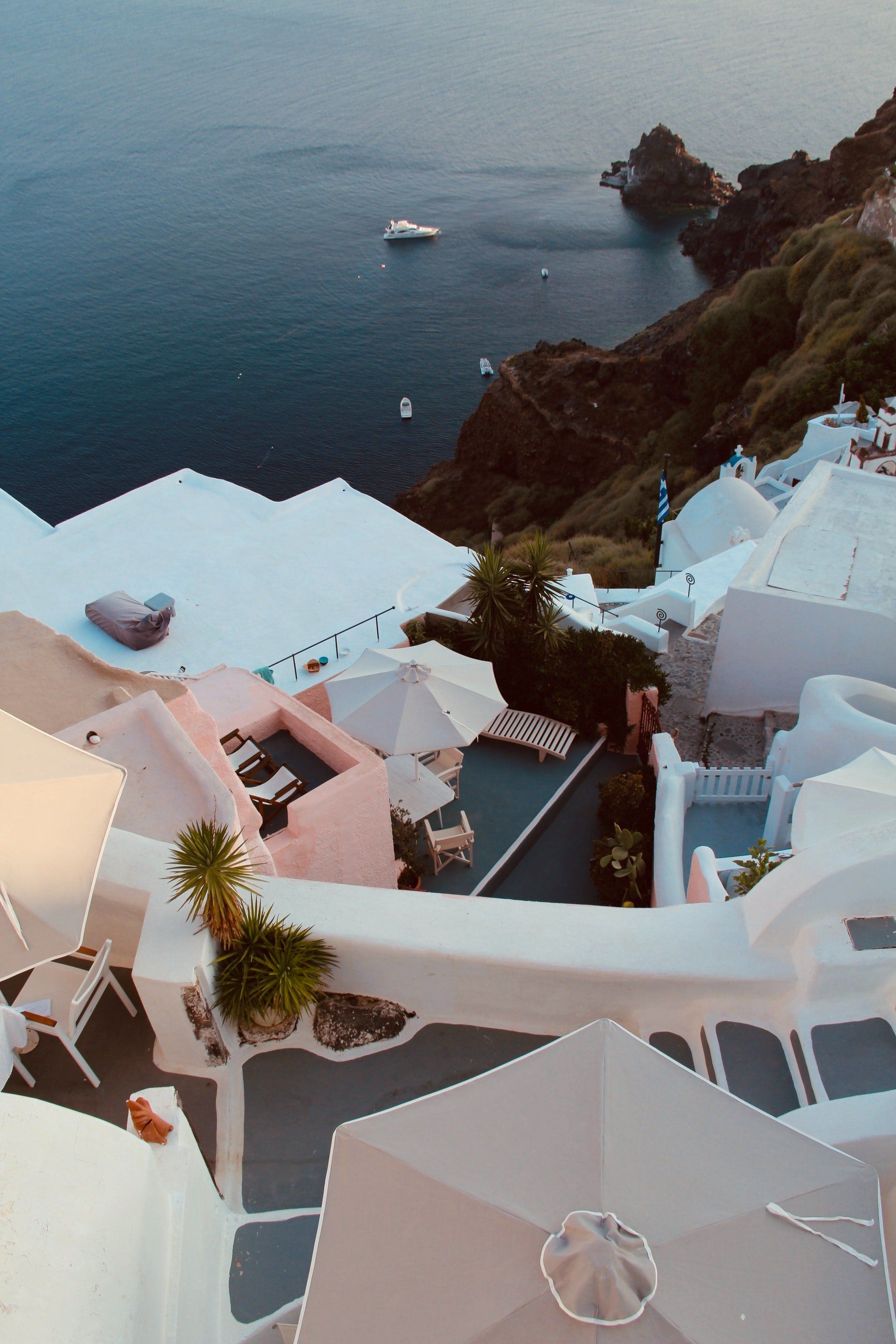 White buildings with blue accents overlooking the Aegean Sea.