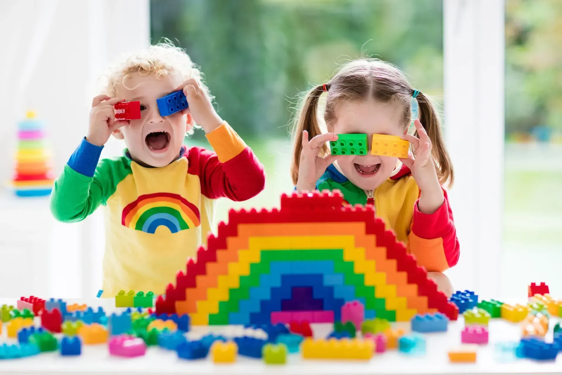 A Boy And A Girl Are Playing With Colorful Lego Blocks — Moruya Drive Child Care Centre In Port Macquarie, NSW