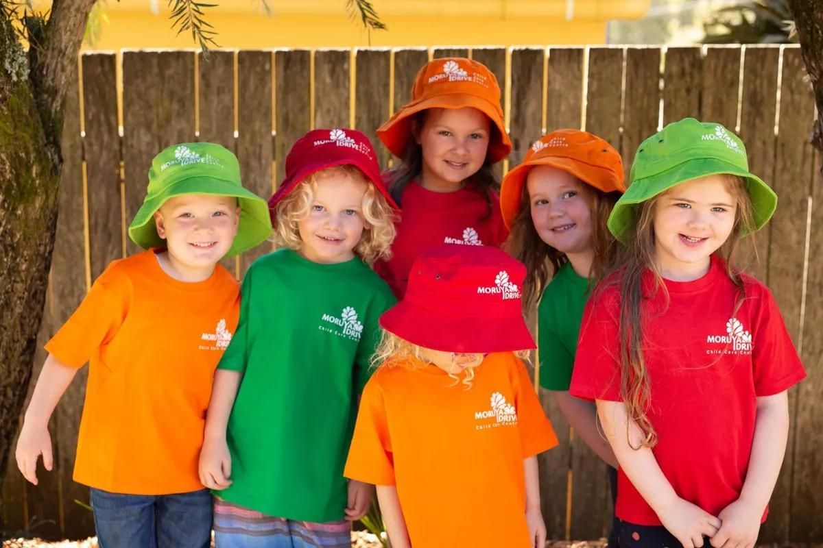 A Group Of Children Wearing Hats And Shirts Are Posing For A Picture — Moruya Drive Child Care Centre In Port Macquarie, NSW