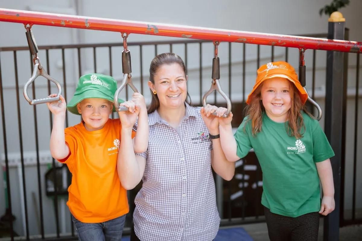 A Woman And Two Children Are Posing For A Picture On A Playground — Moruya Drive Child Care Centre In Port Macquarie, NSW