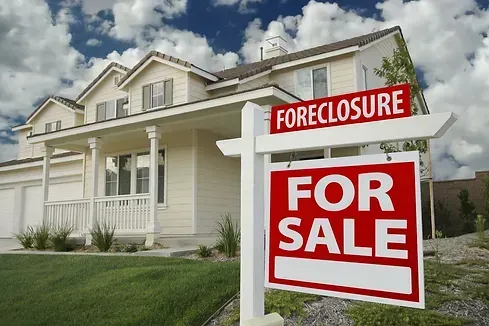 A house with a foreclosure sign in front of it