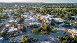 An aerial view of a small town surrounded by trees and buildings.