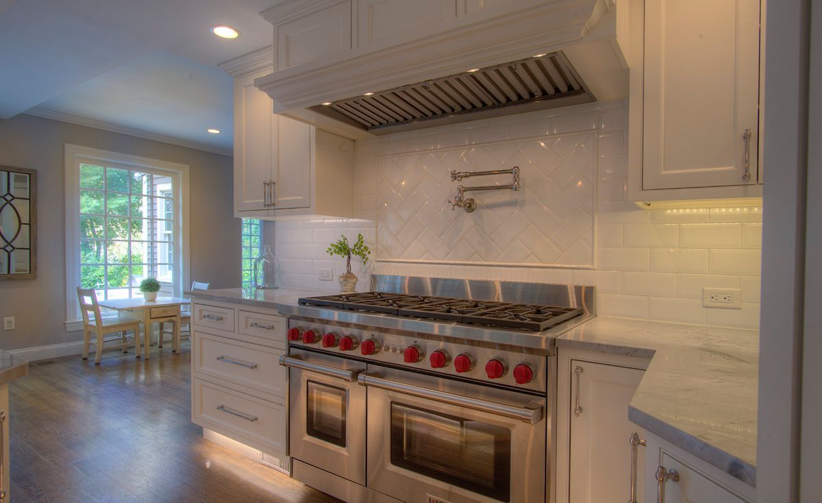 Two green irrigation control boxes installed in a trench, near a brick border.