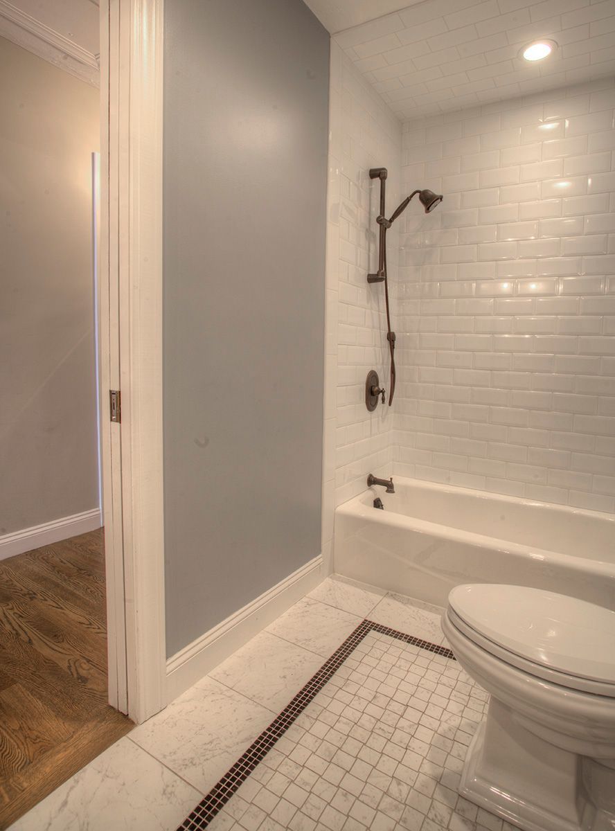 Copper pipes and heating equipment mounted on a black wall in a mechanical room.