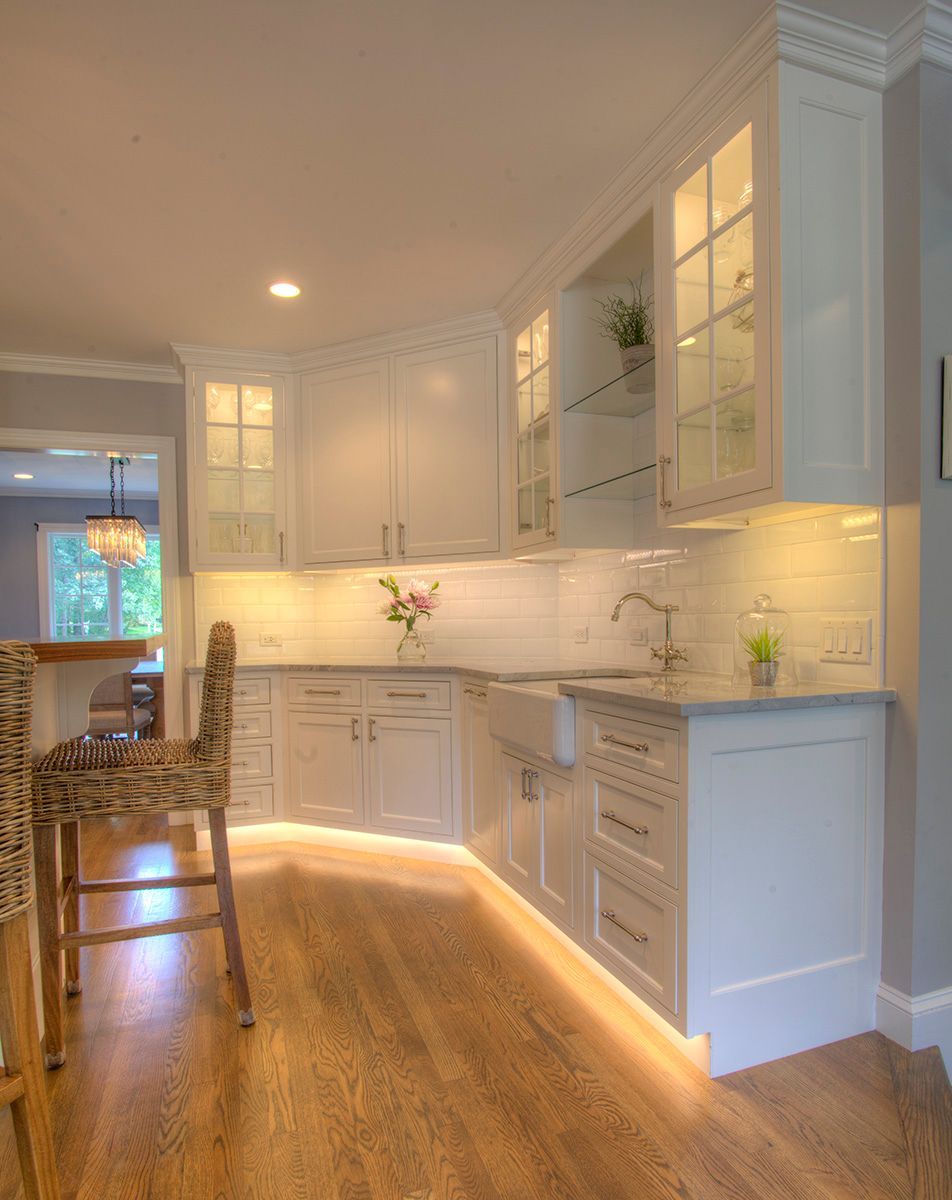 White enclosure with radiant floor heating manifold, red PEX tubing, gauges, and controls.