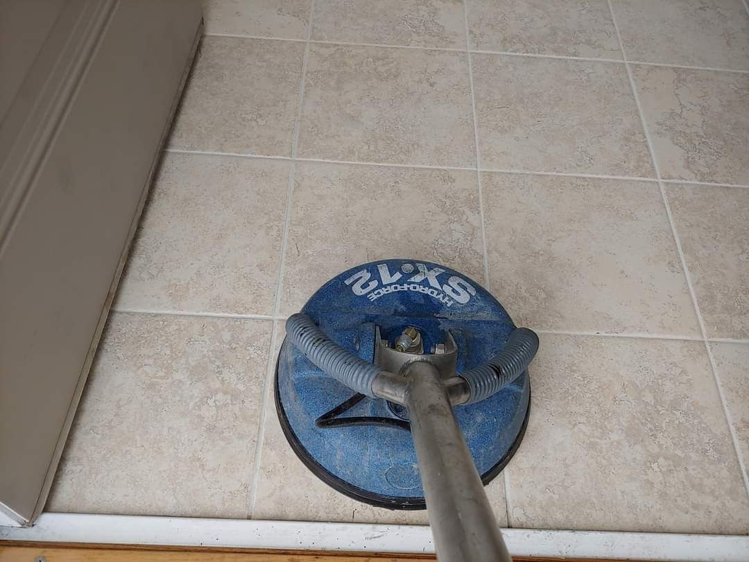 A vacuum cleaner is being used to clean a tile floor.