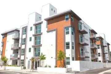 The Centennial Apartments imposing and modern building facade that feature landscaped garden walkways