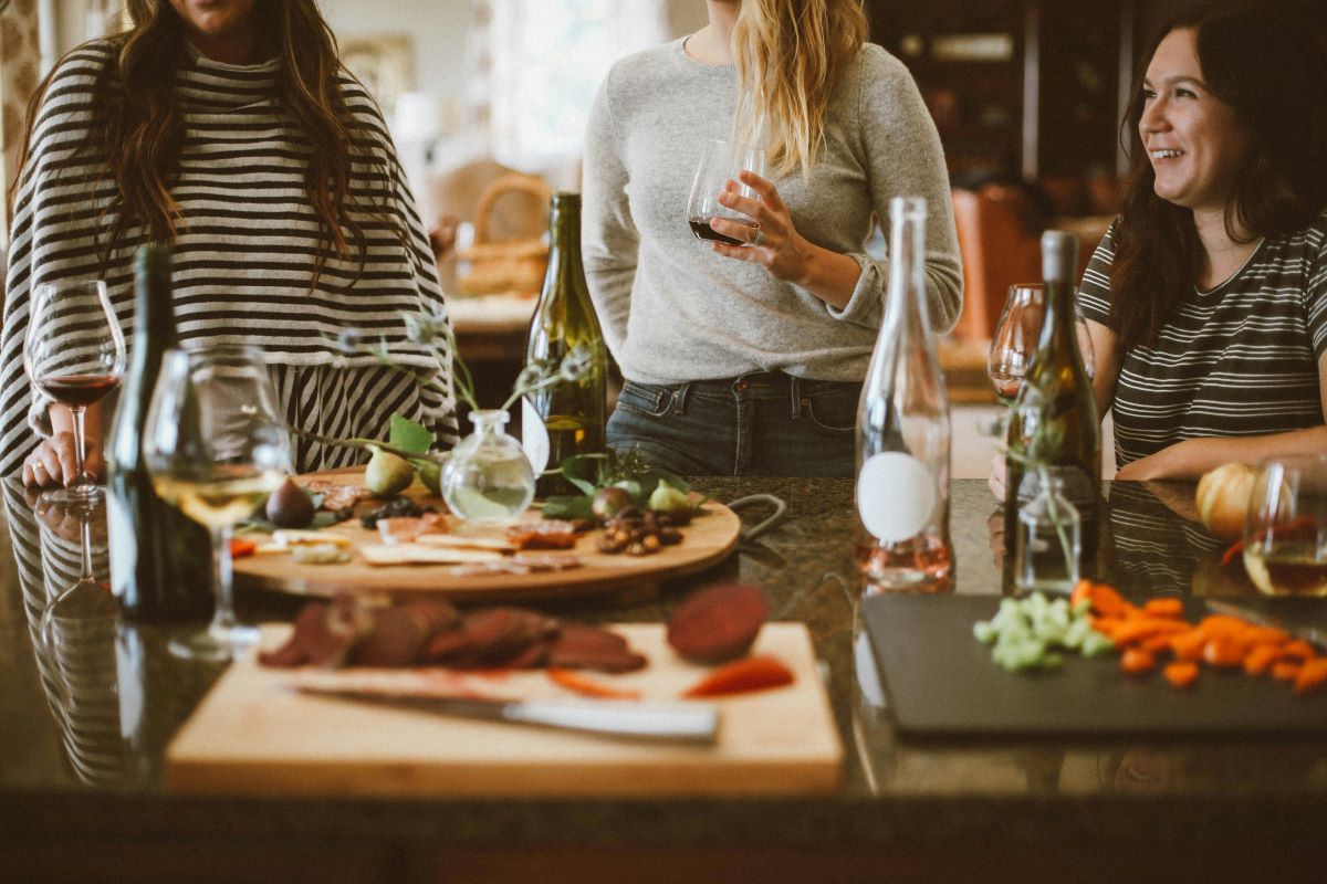 photo of three women happily chatting and eating