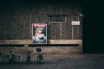 A lighted poster as an outdoor advertising space on a vacant wall of the apartment building