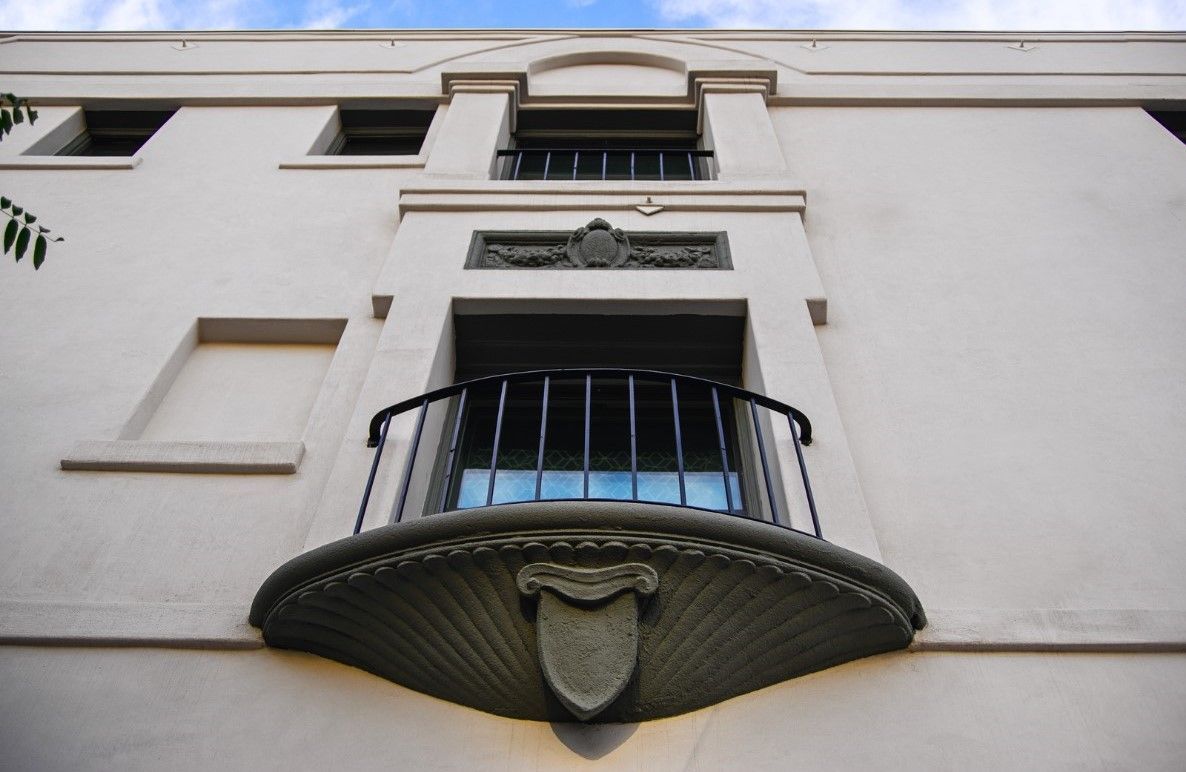 worm's eye view exterior photo of the stylish architecture of a balcony and window at the Ansley Apartments