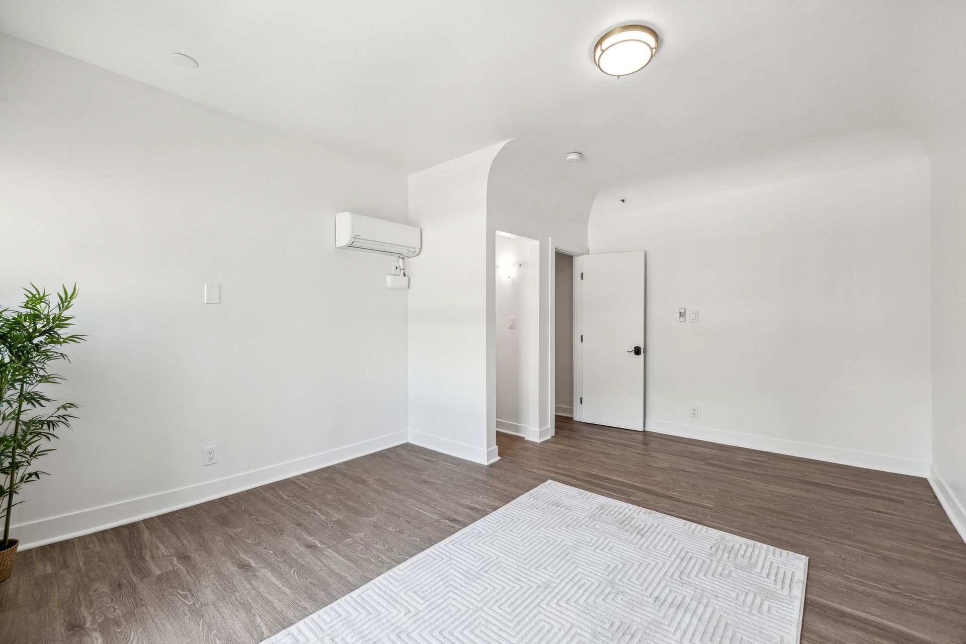 photo of the Ansley's studio interior showing 2 huge windows with curtains, that make unit naturally bright