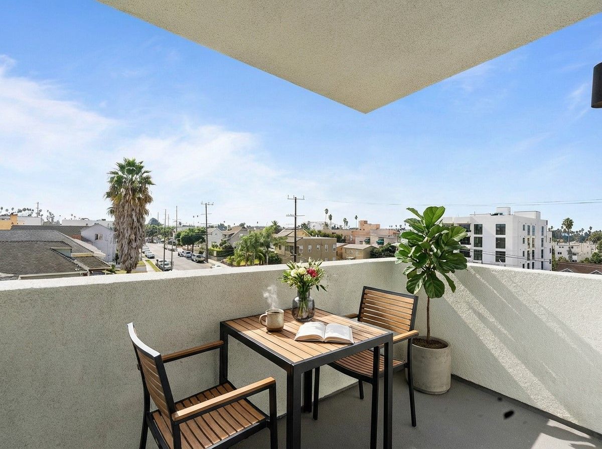 Photo of the huge, modern, and bright kitchen and living room area leading to the balcony in a unit at The Secret in K-Town
