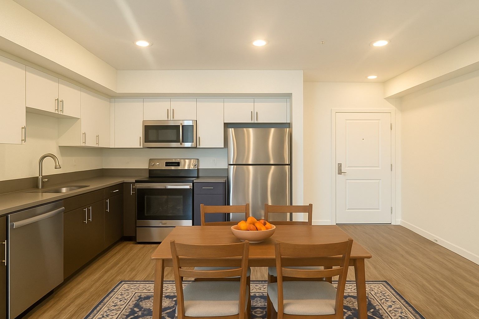 Modern kitchen with wood cabinets, stainless steel appliances, and dining area at Cloud Nine Luxury Apartments