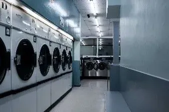 A row of front loading washing machine in common areas of an apartment building