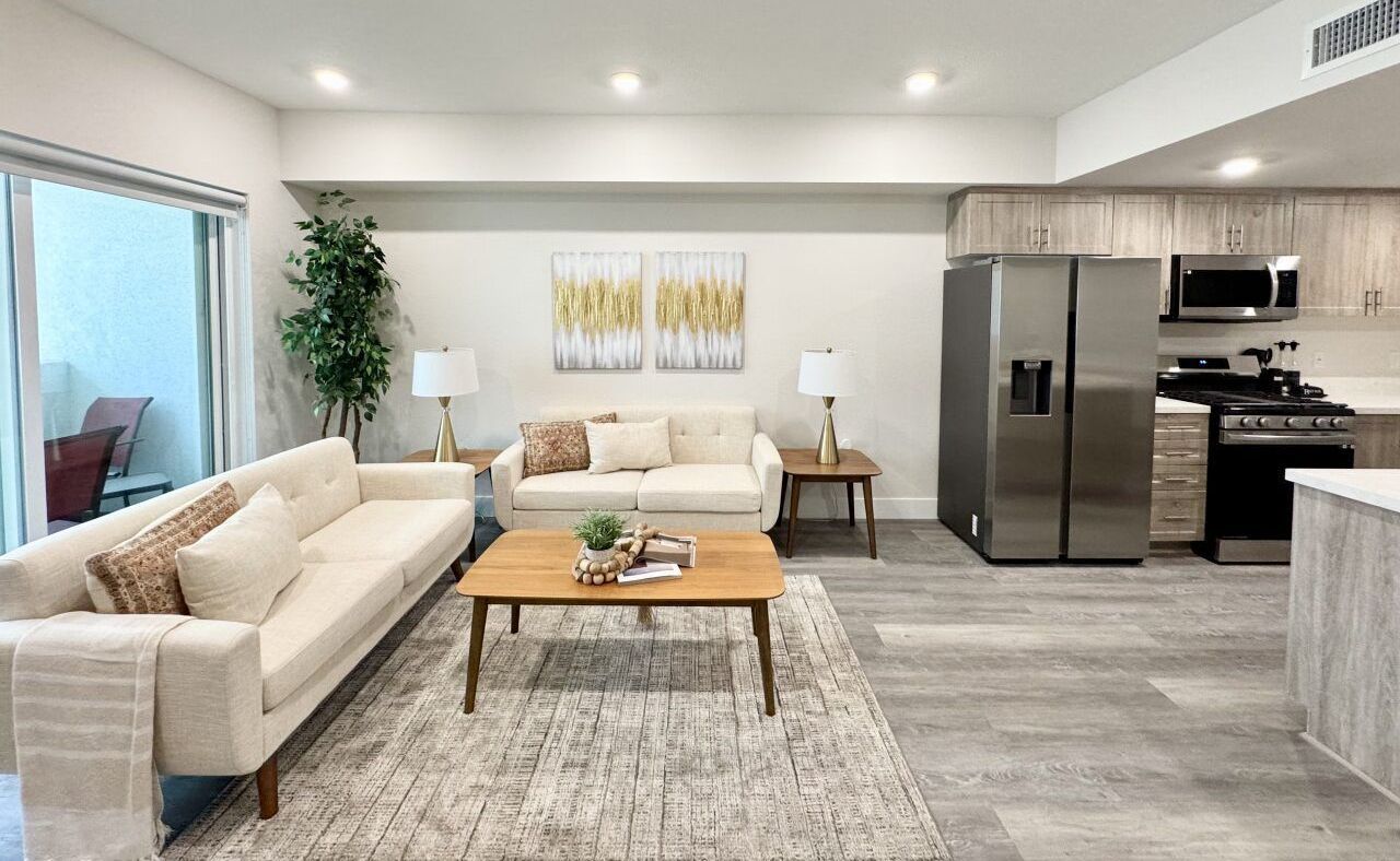 The Hobart Apartments' interiors showing a modern kitchen with stainless appliances and an in-unit washer and dryer