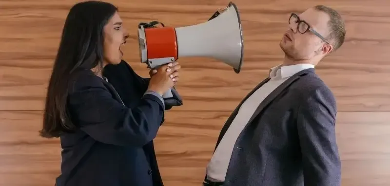 On the left is the difficult tenant with a megaphone shouting at the bending away property manager on the right