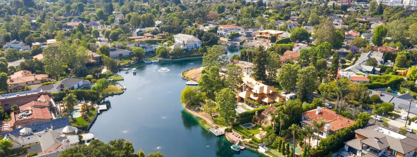 Aerial view of a lake surrounded by a residential area. 