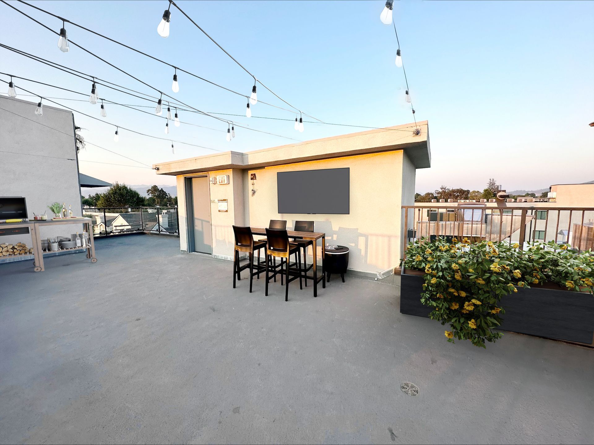 Photo showing an the Mix Luxury Apartment rooftop that features outdoor barbecue, outdoor tables and TV