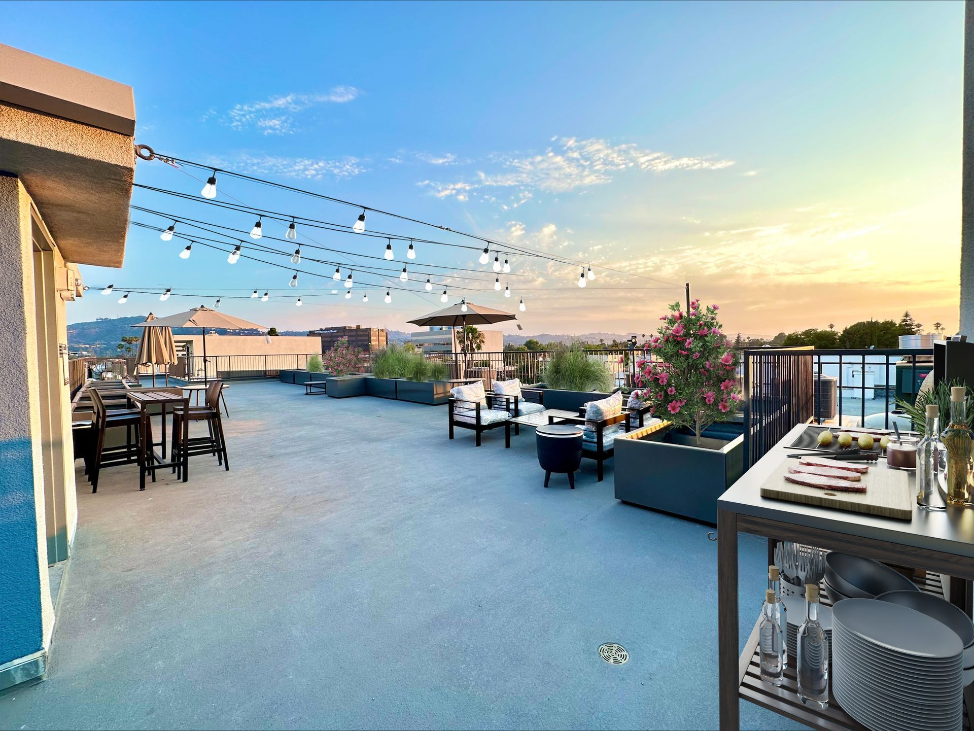 Photo showing an the Mix Luxury Apartment rooftop showing the outdoor barbecue, roof top tables and lovely plants