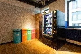 Lighted and accessible vending machine dispensing snacks and beverages, in an apartmnent's comon area