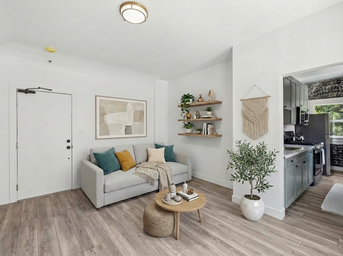 Interior photo of the Ansley Apartments, showing 2 huge windows with curtains and lots of natural light
