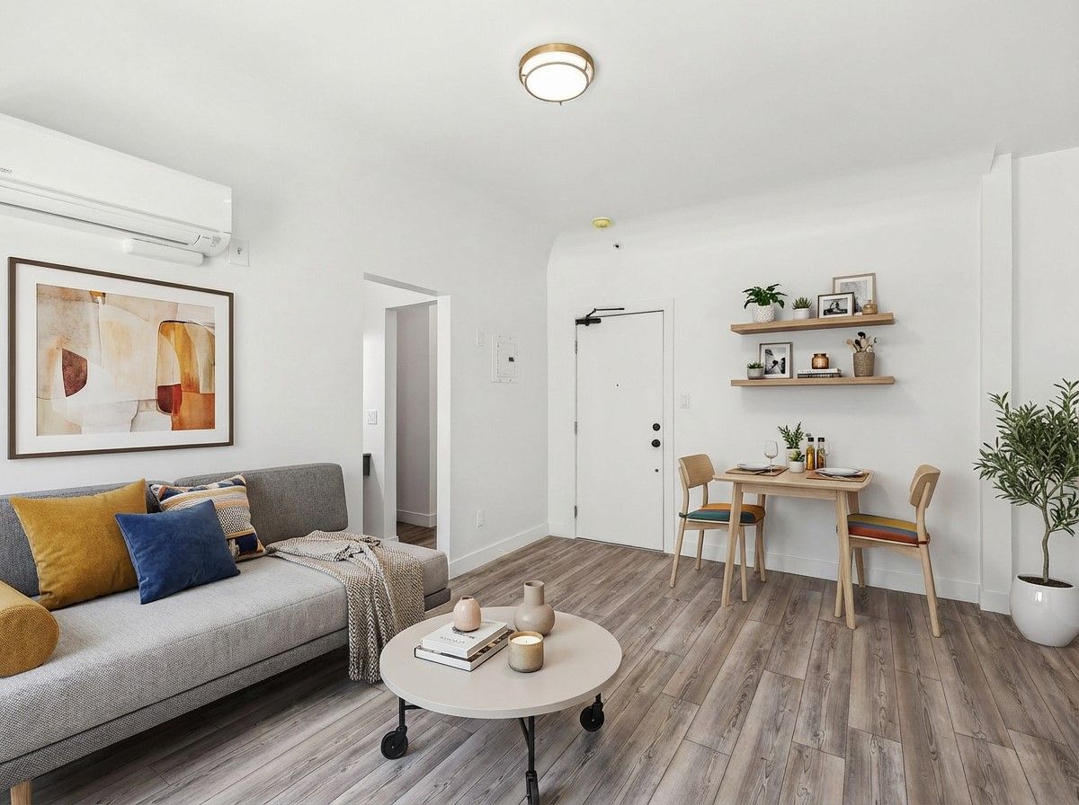 photo of the Ansley's studio interior showing 2 huge windows with curtains, that make unit naturally bright