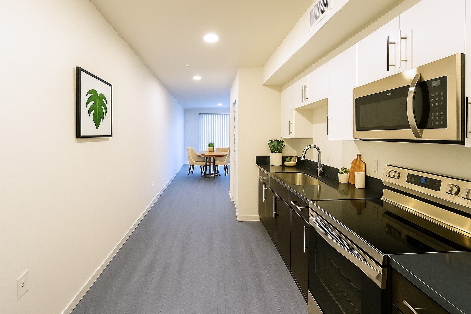 photo of The Centennial's cozy and bright bedroom with a bed, side table and windows with opened blinds