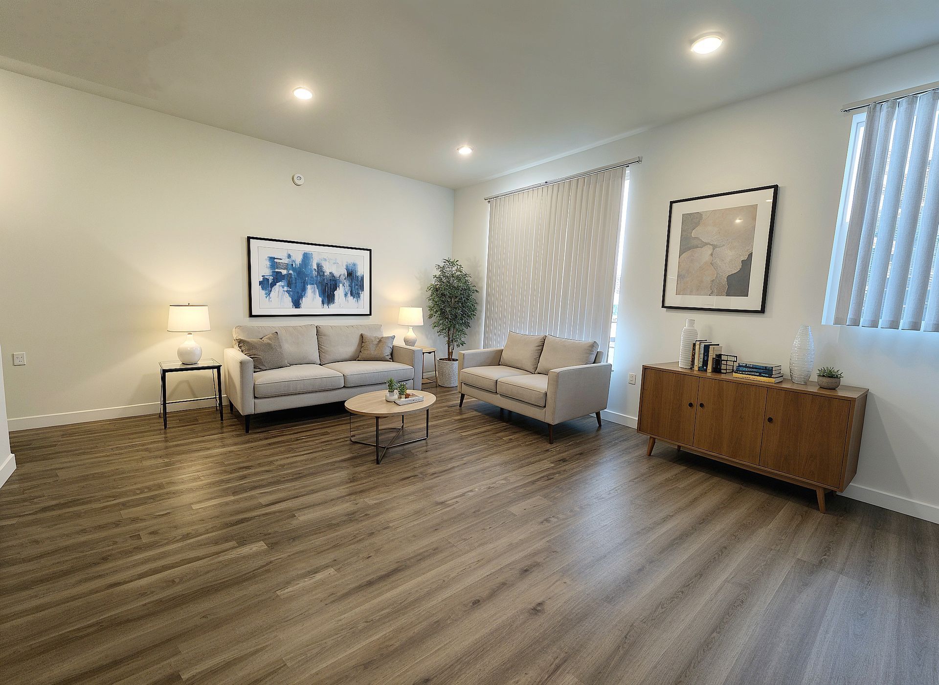photo of The Centennial's modern kitchen showing a stainless steel refrigerator, range oven, microwave, and sink