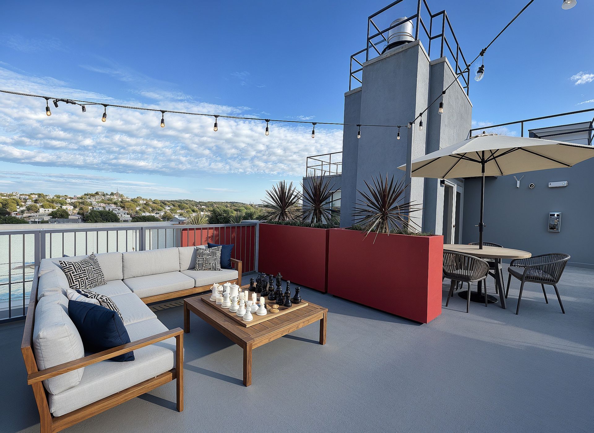 photo of Cloud Nine outdoor amenity, showing a spacious roof deck with plants, lights and furnishings