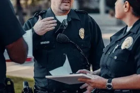 Police officers in uniform and wearing badge ready for calls reporting illegal activity