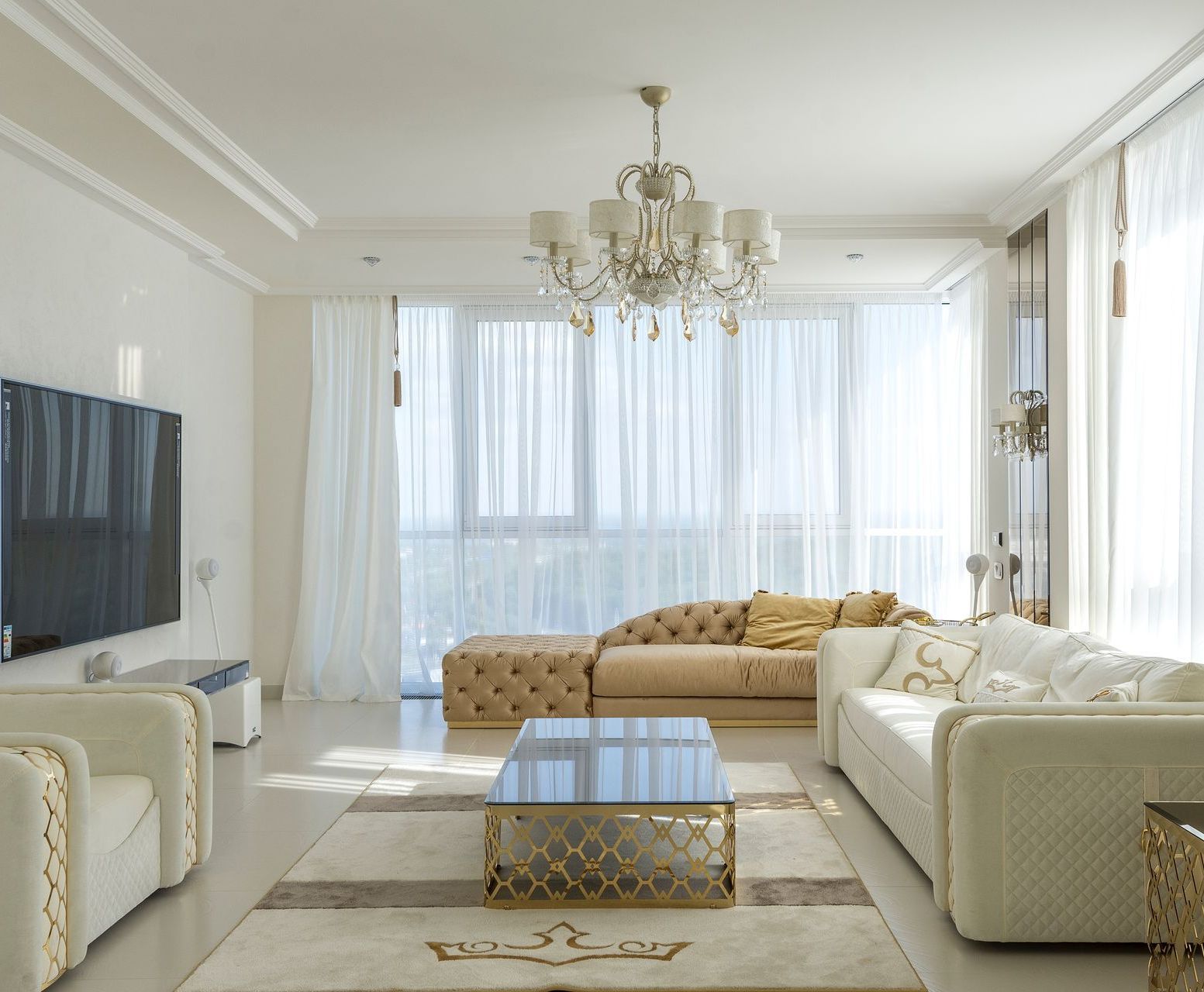 image of a spacious and bright apartment interior living room wih a sofa set, tv, huge windows and chandelier