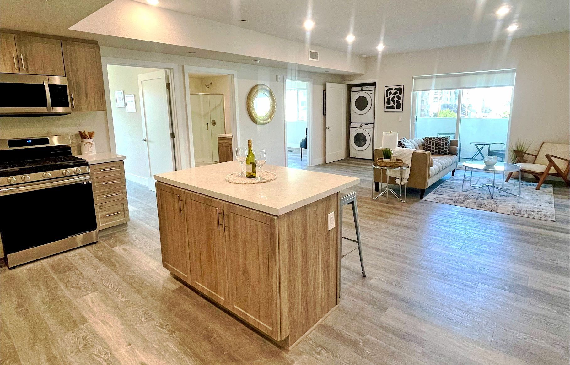 Modern kitchen with wood cabinets, stainless steel appliances, a center island, and an open layout for property management.