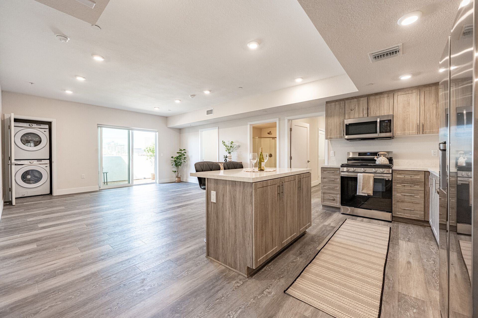 Photo of the huge, modern and bright kitchen and living room area leading to the balcony in a unit at The Secret at K-Town